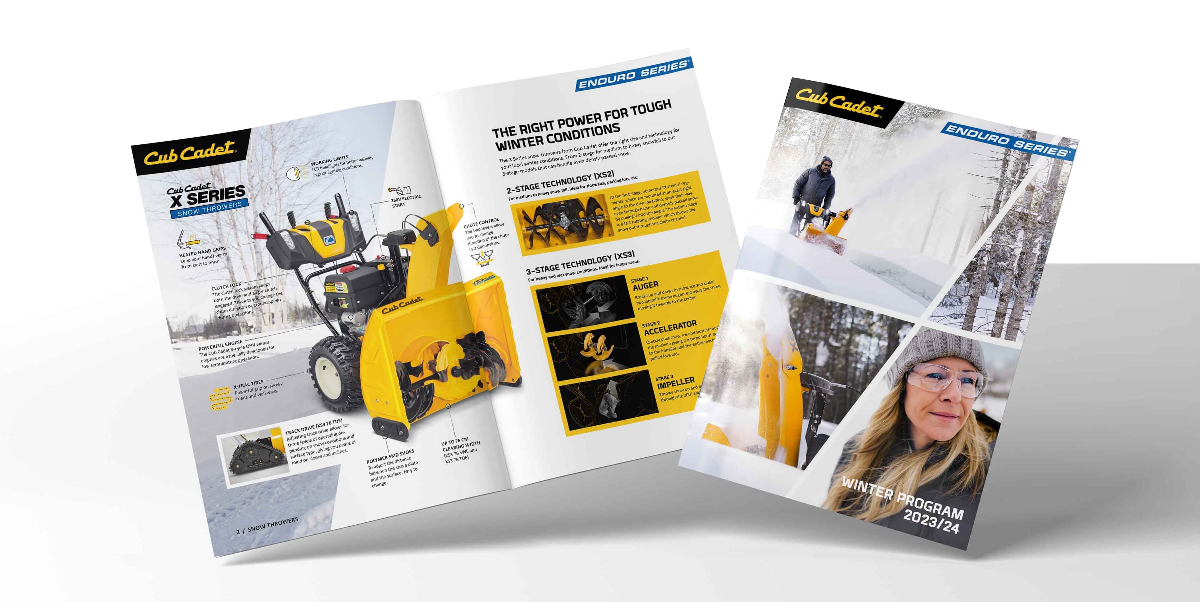 Geöffnete Cub Cadet Broschüre mit Wintermotiven, Schneemaschinen und markentypischer Gestaltung.